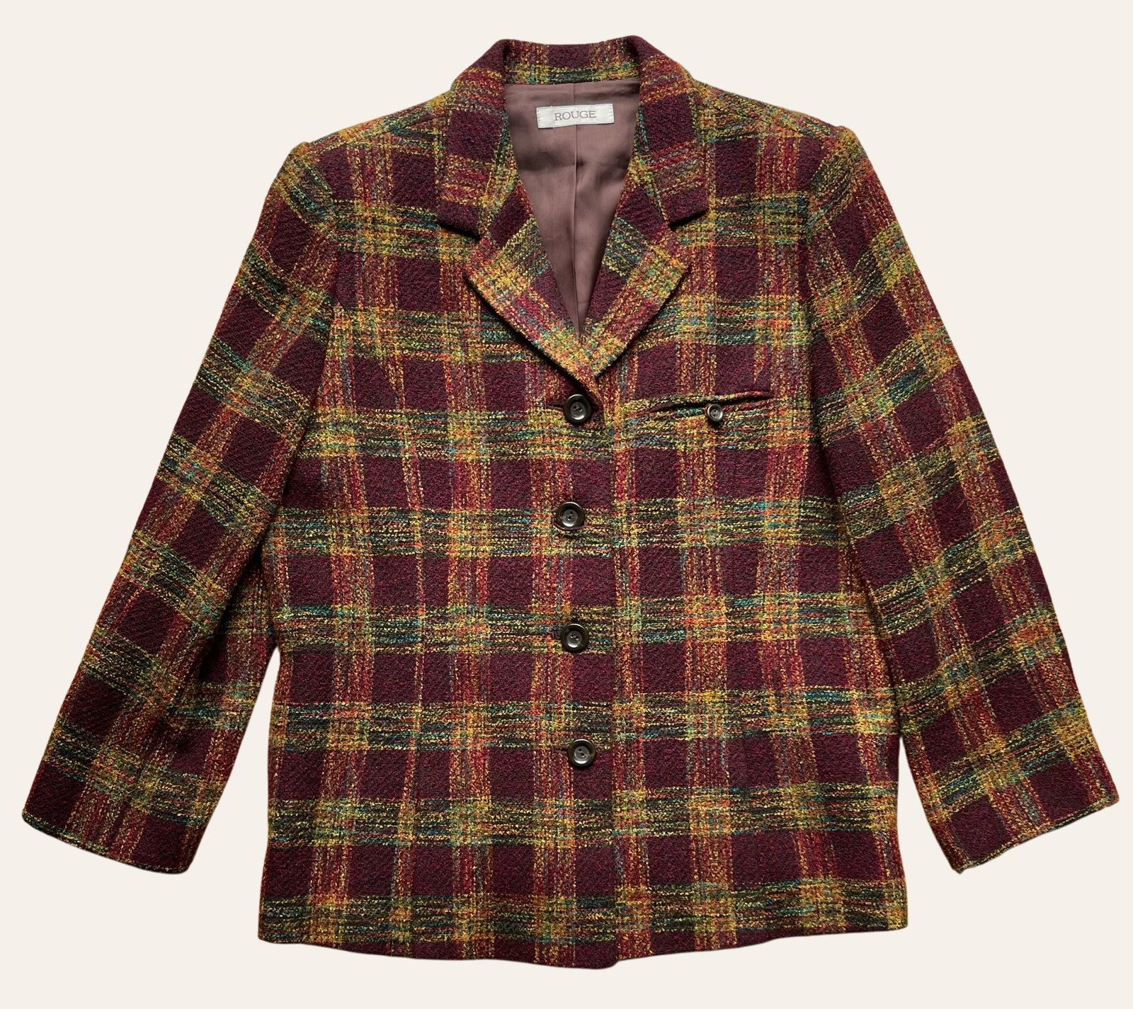 A vintage checked wool jacket photographed flat on a plain background