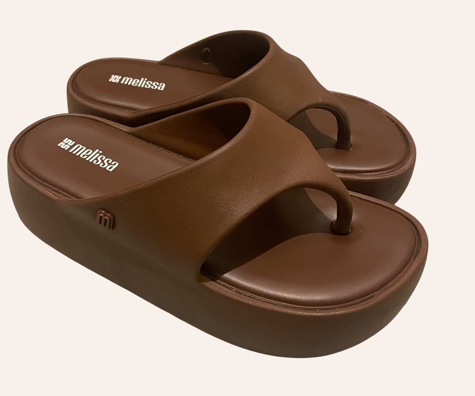 A pair of worn secondhand leather sandals photographed flat