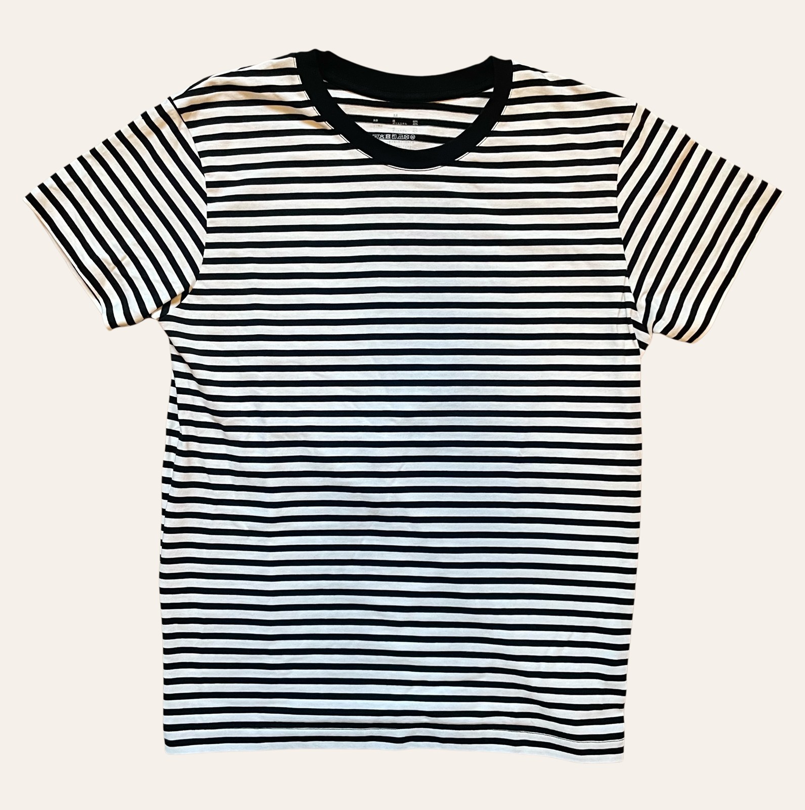 A plain, soft Muji-style top photographed flat on a plain background
