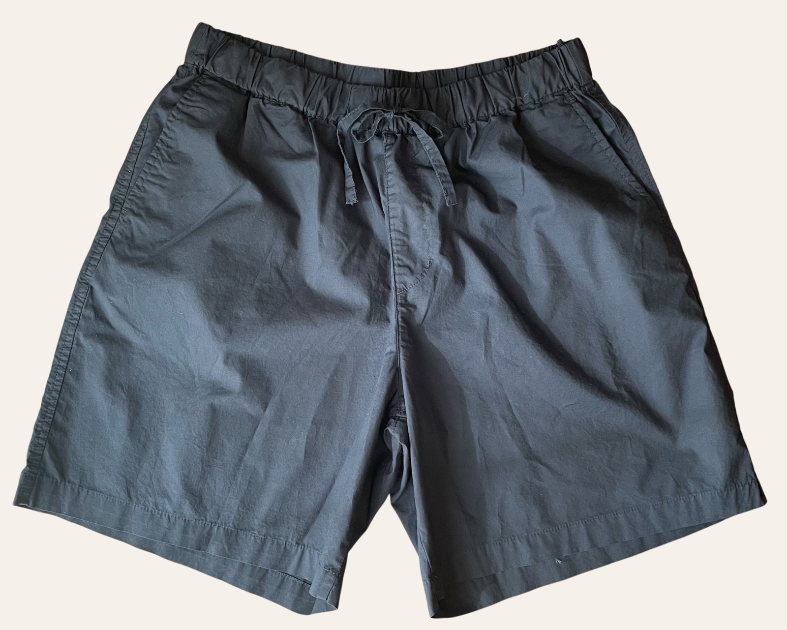 A pair of relaxed Muji-style trousers photographed flat